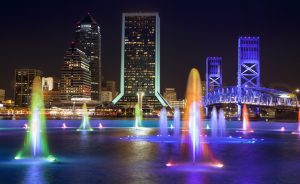Jacksonville, Friendship Fountain and cityscape at dusk in Florida USA.  Downtown city sky line from the south bank of the St. Johns River